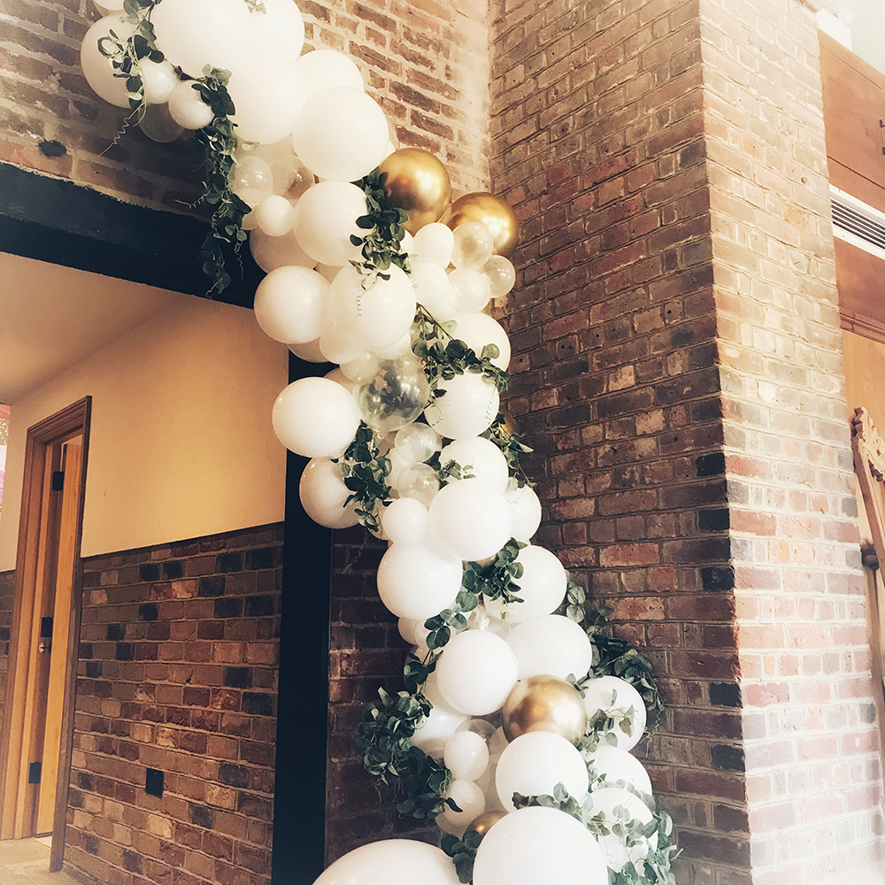 White and gold balloon garland with foliage